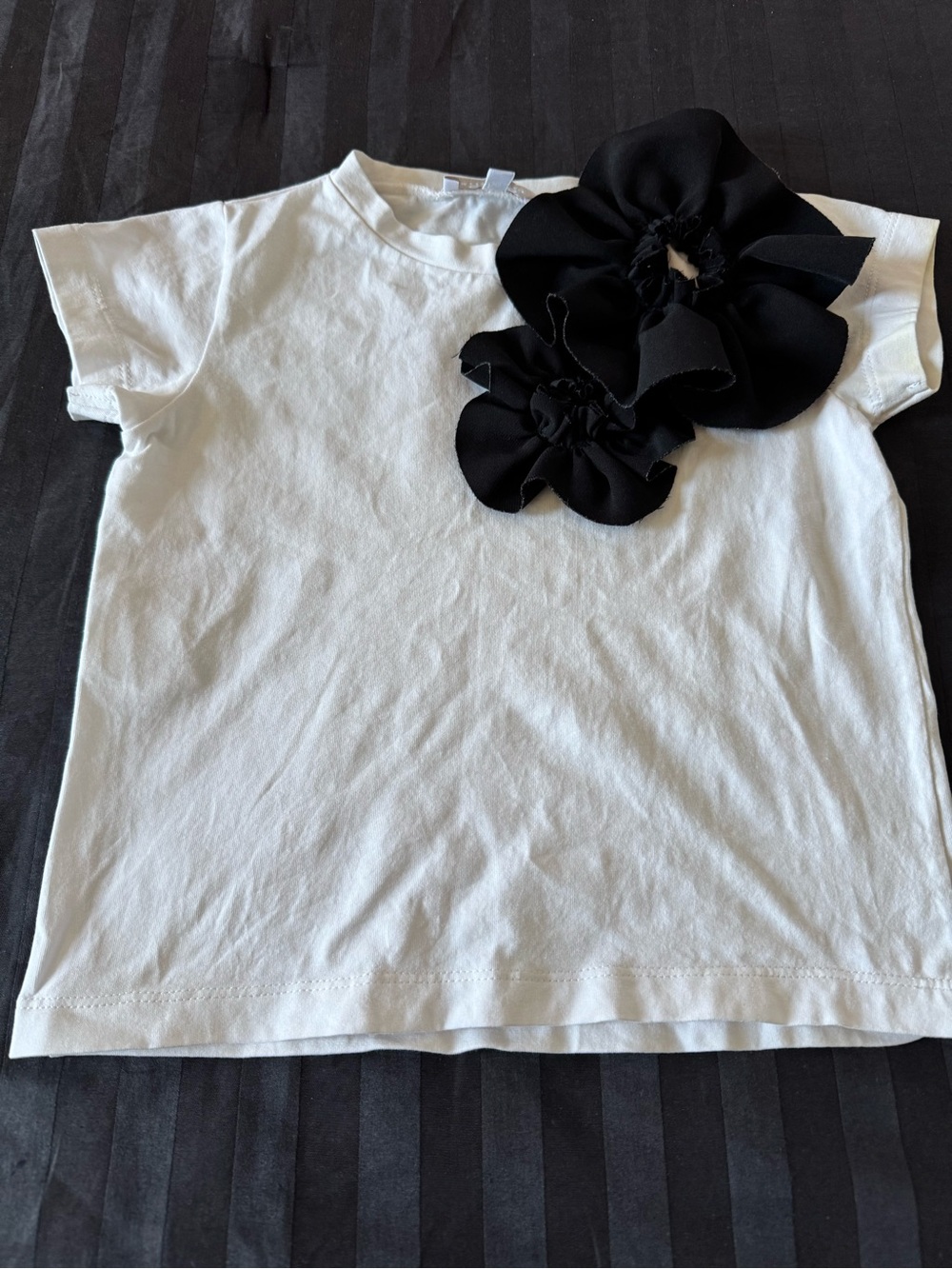 Girls White Short-Sleeve Tee with Black Floral Accents
Cotton top, runs small
